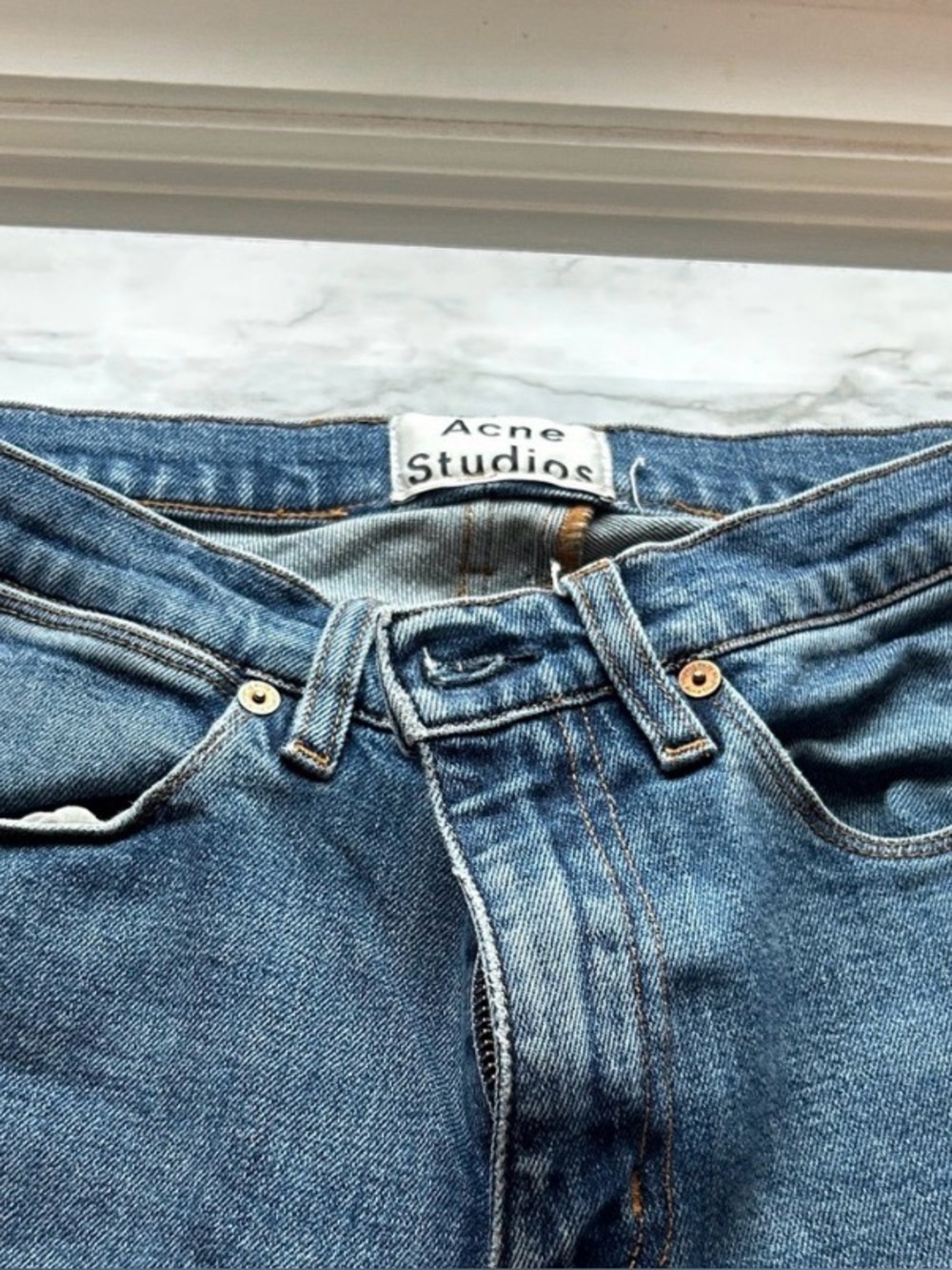 Acne Studios light blue denim jeans with tan stitching